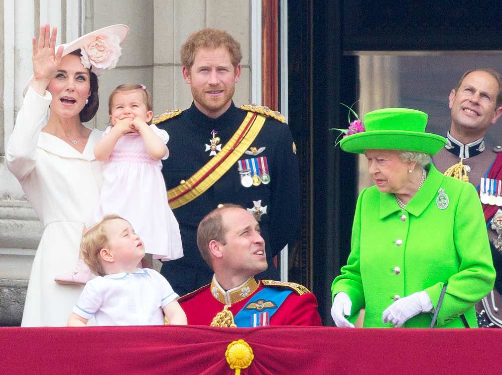 Catherine, Duchess of Cambridge holding her daughter Princess Charlotte, Prince George, Britain's Prince William, Duke of Cambridge, Britain's Prince Harry and Britain's Queen Elizabeth II stand on the balcony of Buckingham Palace to watch a fly-past of aircrafts by the Royal Air Force, in London on June 11, 2016.