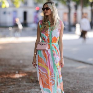 PARIS, FRANCE - JULY 06: Mandy Bork seen wearing brown sunglasses from Tom Ford, a colorful buttoned / pleated / sleeveless long dress from Emilio Pucci, a pale pink Hermes Kelly mini bag and white creme sandals from Chanel, during Paris Fashion Week - Haute Couture Fall Winter 2022 2023, on July 06, 2022 in Paris, France. (Photo by Jeremy Moeller/Getty Images)