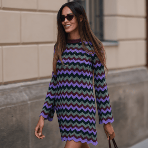 Jill Asemota is seen wearing a purple, blue and green midi Missoni dress, a brown Hermes Constance leather bag and black Fendi sunnies on July 28, 2022 in Berlin, Germany.