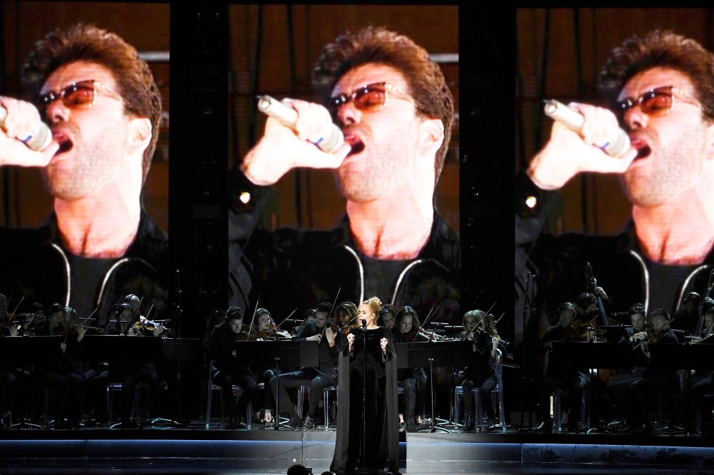 An image of the late George Michael is projected on a video screen while recording artist Adele performs on stage.
