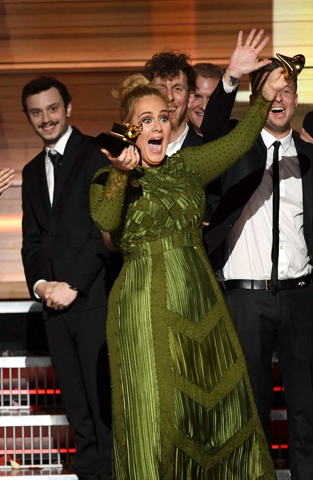 Adele breaks her Grammy in half at the 2017 awards show.