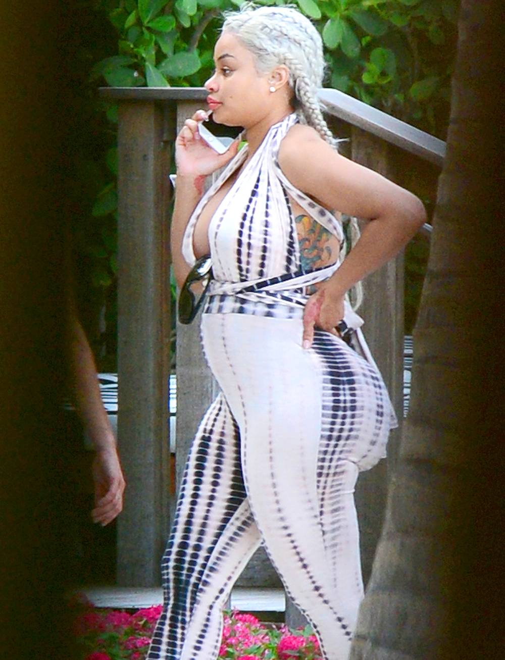 Blac Chyna shows her baby bump in tie-dye jumpsuit while dining with a couple of friends at the W Hotel.