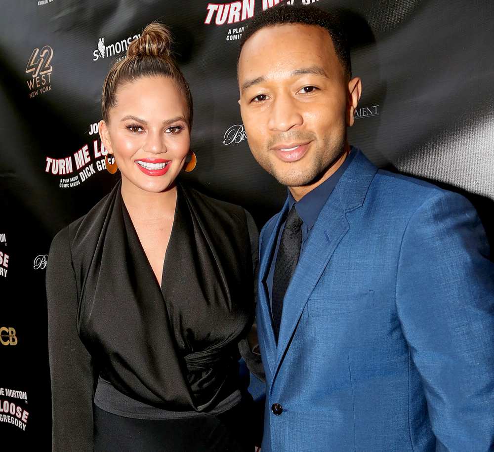 Chrissy Teigen and John Legend pose at the opening night of 'Turn Me Loose.'