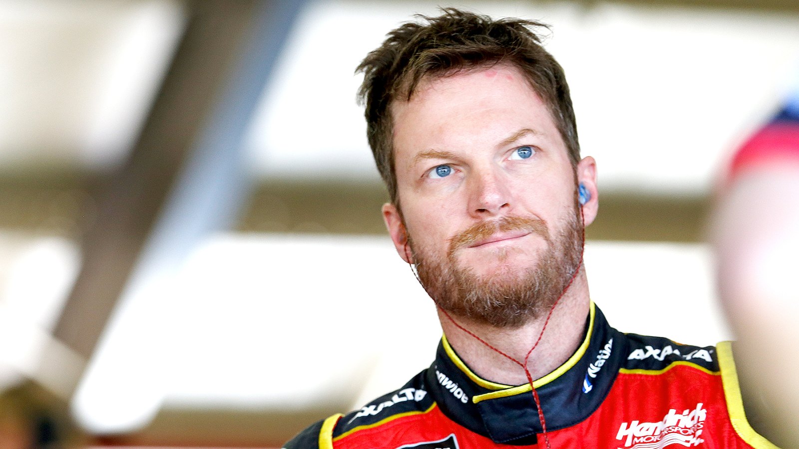 Dale Earnhardt Jr, driver of the #88 Axalta Chevrolet, stands in the garage during practice for the Monster Energy NASCAR Cup Series Auto Club 400 at Auto Club Speedway on March 24, 2017 in Fontana, California.