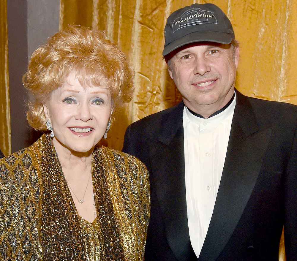 Debbie Reynolds and Todd Fisher pose in the trophy room at TNT's 21st Annual Screen Actors Guild Awards at the Shrine Auditorium on Jan. 25, 2015, in Los Angeles.
