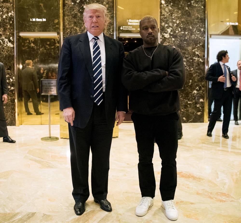 Donald Trump and Kanye West stand together in the lobby at Trump Tower, December 13, 2016 in New York City.