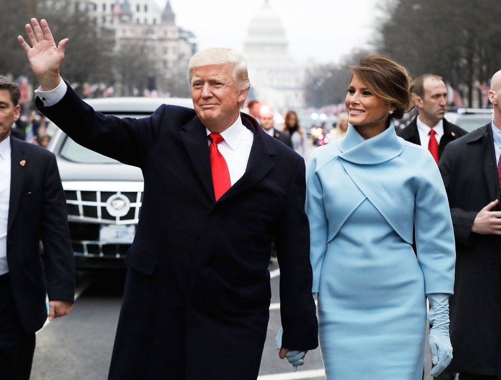 U.S. President Donald Trump waves while walking with U.S. First Lady Melania Trump during a parade following the 58th presidential inauguration in Washington, D.C., U.S., on Friday, Jan. 20, 2017.