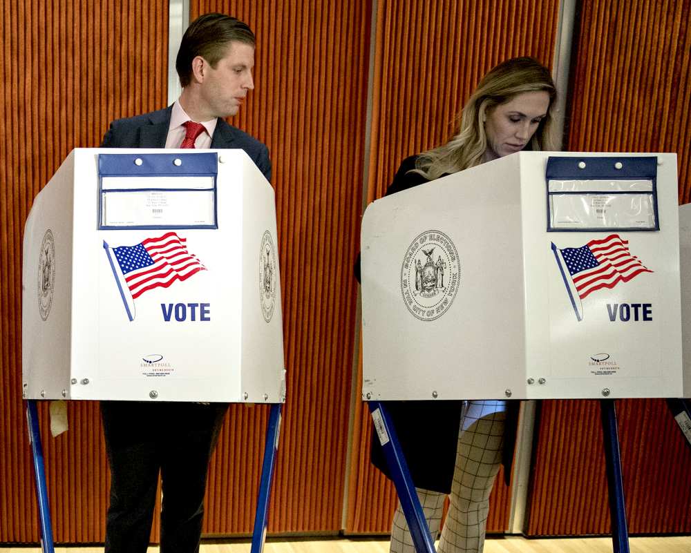 Eric Trump, son of of Republican Presidential Nominee Donald Trump, looks at Lara Yunaska's, wife of Eric Trump, voting booth at the 53rd Street Library in New York, U.S., on Tuesday, Nov. 8, 2016.
