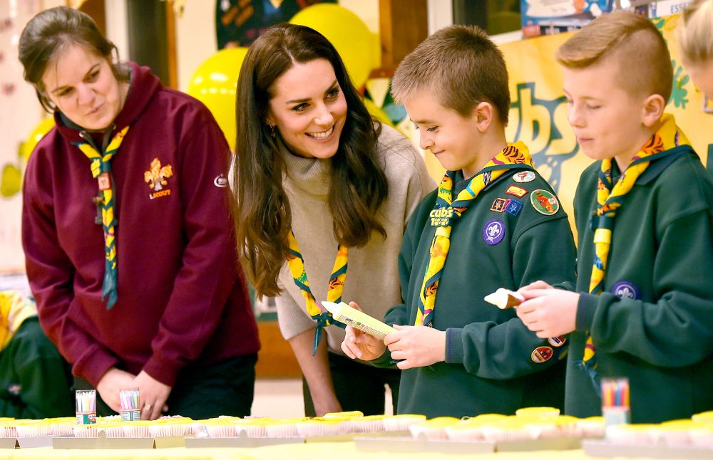 Britain's Catherine, Duchess of Cambridge (2L), ices cupcakes during a Cub Scout Pack meeting with cubs from the Kings Lynn District, in Kings Lynn, eastern England, on December 14, 2016, to celebrate 100 years of Cubs. The Duchess attended a special Cub Scout Pack meeting with Cubs from the Kings Lynn District to celebrate 100 years of Cubs. Cub Scouting was co-founded by Robert Baden-Powell and Vera Barclay on the 16th December 2016.