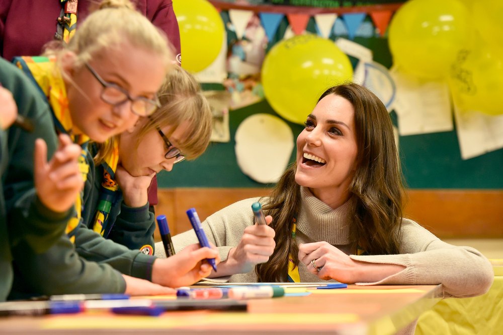 Britain's Catherine, Duchess of Cambridge, reacts as she talks with cubs during a Cub Scout Pack meeting with cubs from the Kings Lynn District, in Kings Lynn, eastern England, on December 14, 2016, to celebrate 100 years of Cubs. The Duchess attended a special Cub Scout Pack meeting with Cubs from the Kings Lynn District to celebrate 100 years of Cubs. Cub Scouting was co-founded by Robert Baden-Powell and Vera Barclay on the 16th December 1916.