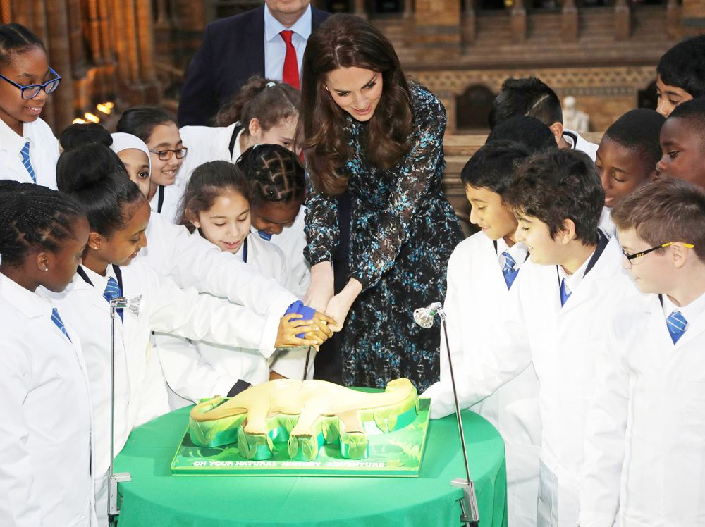 The Duchess of Cambridge cuts a cake with pupils from Oakington Manor Primary School in Wembley, as she attends a children's tea party at the Natural History Museum, London, to celebrate Dippy the Diplodocus's time in Hintze Hall.