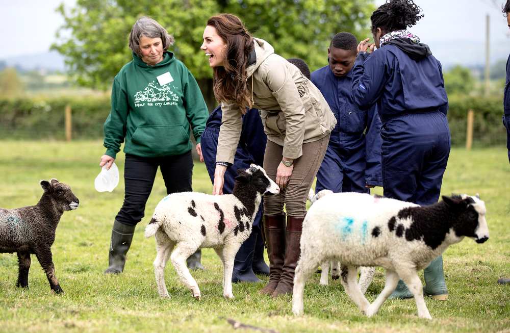 The Duchess of Cambridge with the sheep and lambs and children from Vauxhall primary school in London during a visit to a "Farms for Children" farm on May 3, 2017 in Arlingham, Gloucestershire.