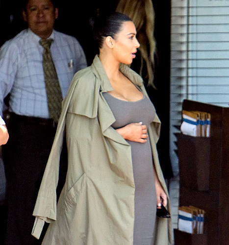 Kim Kardashian (cradles bump)