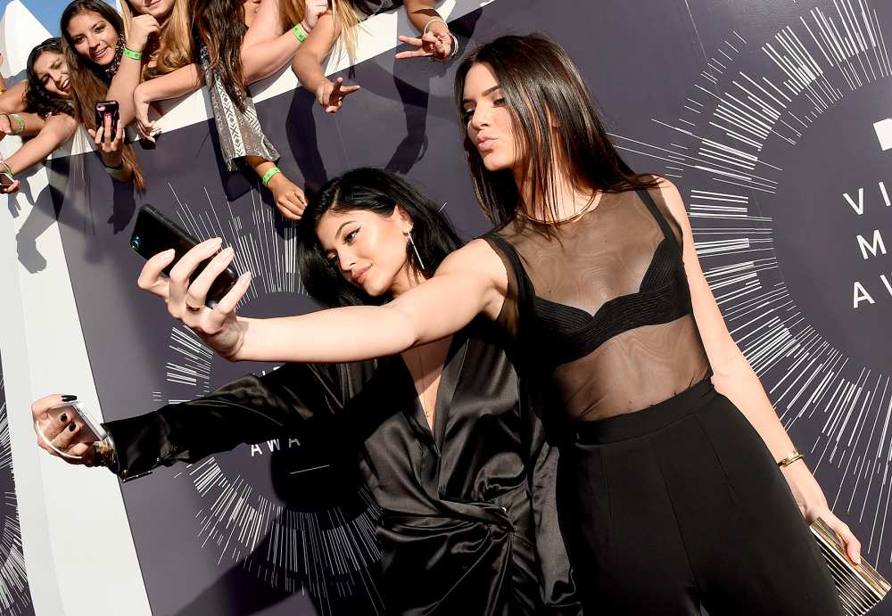 Kylie Jenner and Kendall Jenner take selfies at the 2014 MTV Video Music Awards.