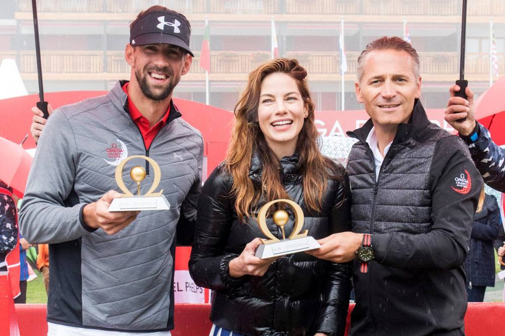 Michelle Monaghan and Michael Phelps shared the winner's trophy at OMEGA's inaugural Celebrity Masters in Switzerland.