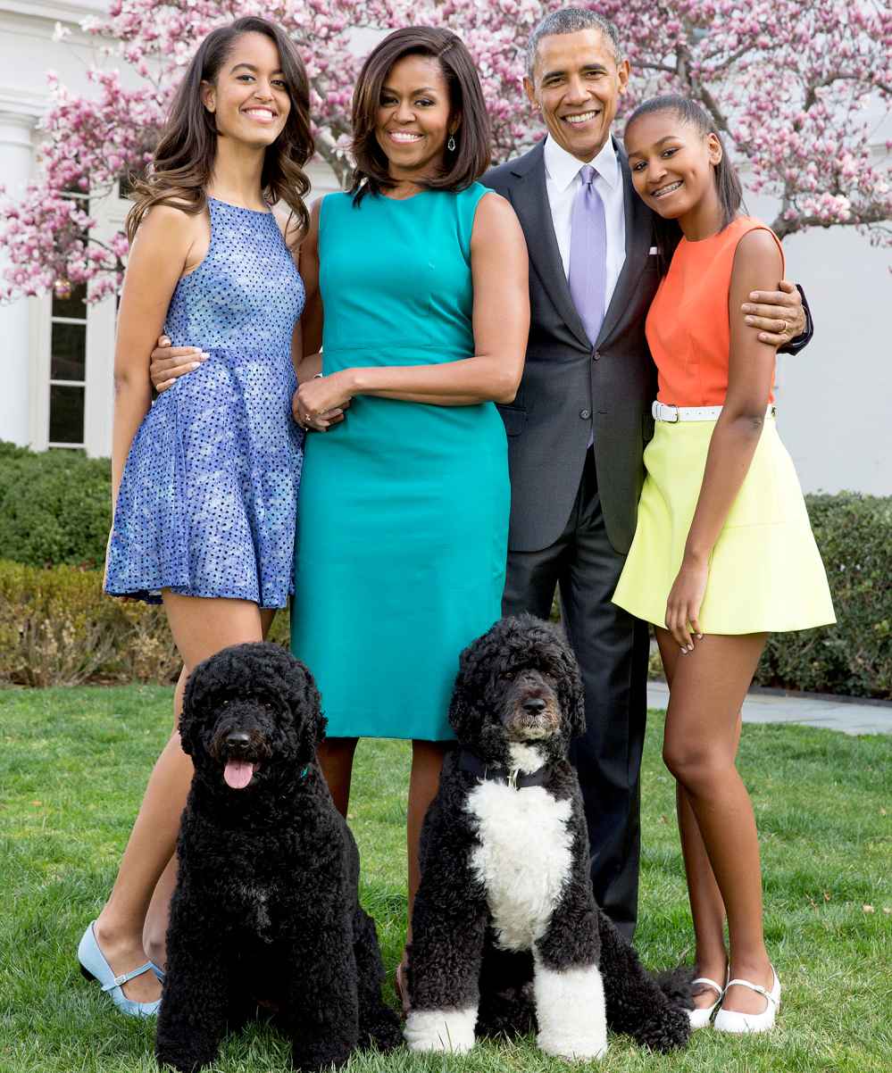 U.S. President Barack Obama, First Lady Michelle Obama, and daughters Malia (L) and Sasha (R) pose for a family portrait with their pets Bo and Sunny in the Rose Garden of the White House on Easter Sunday, April 5, 2015 in Washington, DC.