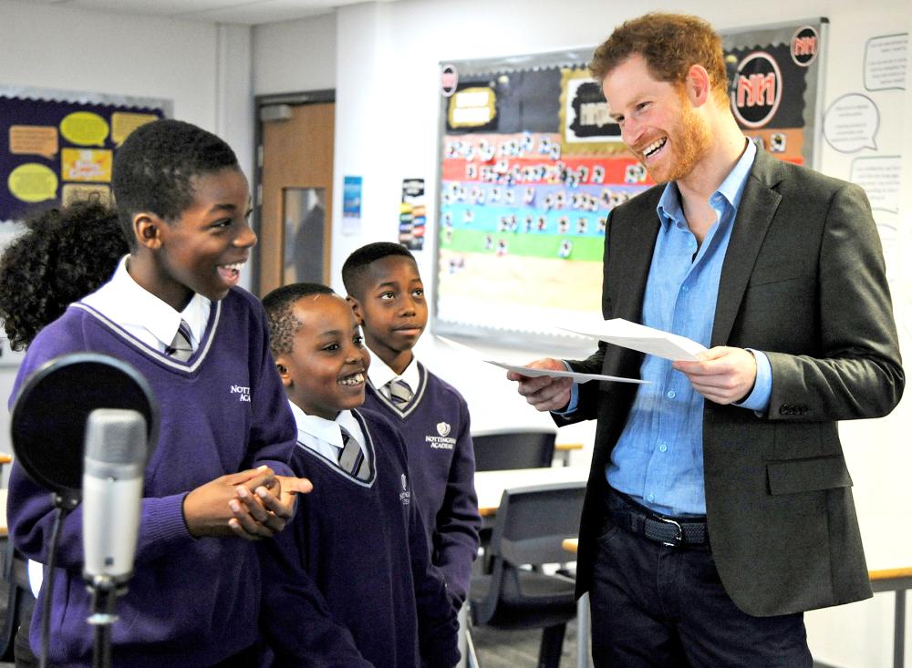 Britain's Prince Harry speaks to pupils at a lyrical writing class during a visit to the Full Effect and Coach Core programmes, two projects supported by The Royal Foundation that work to improve opportunities for young people, at Nottingham Academy, Nottingham, England, Wednesday, Feb. 1, 2017.