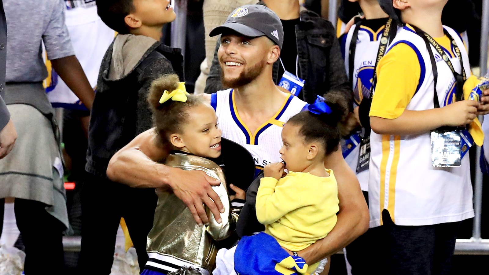Stephen Curry #30 of the Golden State Warriors celebrates holding his daughters Riley and Ryan after defeating the Cleveland Cavaliers 129-120 in Game 5 to win the 2017 NBA Finals at ORACLE Arena on June 12, 2017 in Oakland, California.
