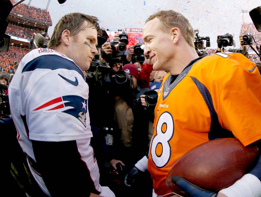Peyton Manning, No. 18, of the Denver Broncos and Tom Brady, No. 12, of the New England Patriots speak after the AFC Championship game at Sports Authority Field at Mile High on January 24, 2016, in Denver.
