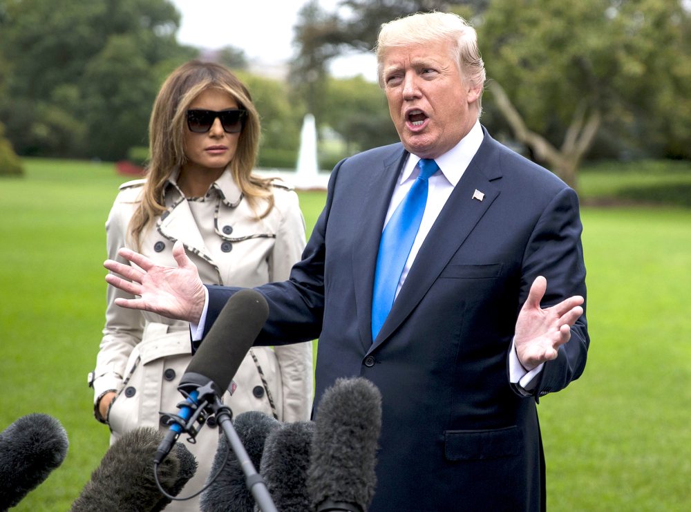 U.S. President Donald Trump, right, speaks to members of the media as First Lady Melania Trump stands before boarding Marine One on the South Lawn of the White House in Washington, D.C., U.S., on Friday, Oct. 13, 2017. Trump plans to visit the U.S. Secret Service training facility in Beltsville, Maryland.