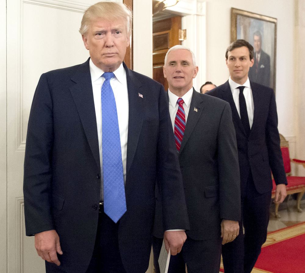 US President Donald Trump arrives alongside Vice President Mike Pence (C) and White House Senior Advisor Jared Kushner (R) during a meeting with manufacturing CEOs in the State Dining Room at the White House in Washington, DC, February 23, 2017.