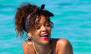 Rihanna Sunbathes on Surfboard in Black Thong Bikini | Us Weekly