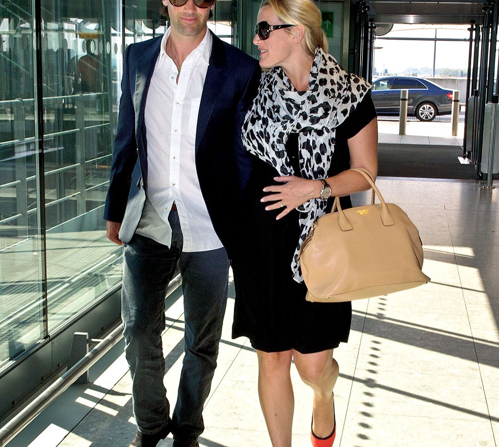 Pregnant Kate Winslet and Ned Rock 'n Roll depart Heathrow Airport