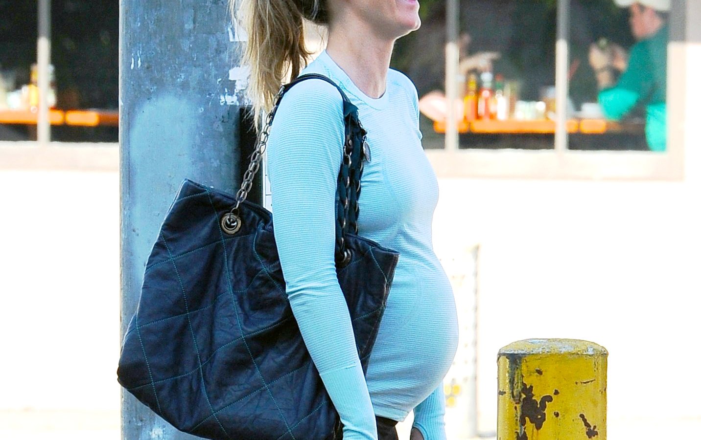 Emily Blunt shows off her growing baby bump as she goes to Hugo's