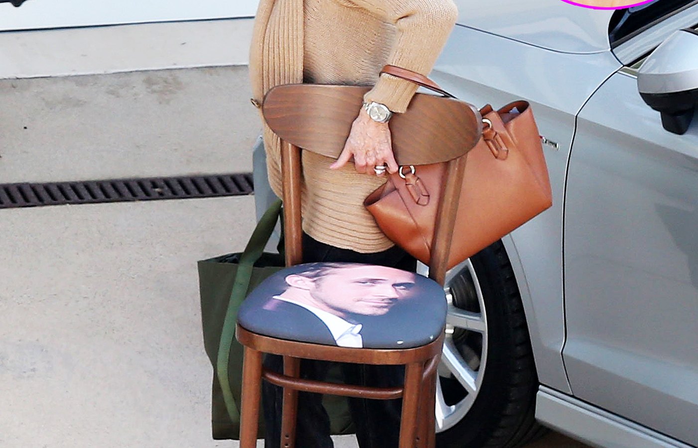 Jane Fonda carries a chair with Ryan Gosling's face on it