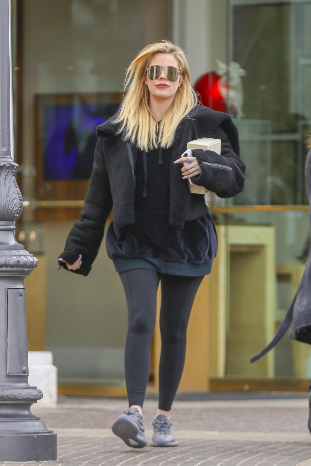 Khloe Kardashian hides her baby bump while out at Polacheck's Jewelers in Calabasas on December 23.