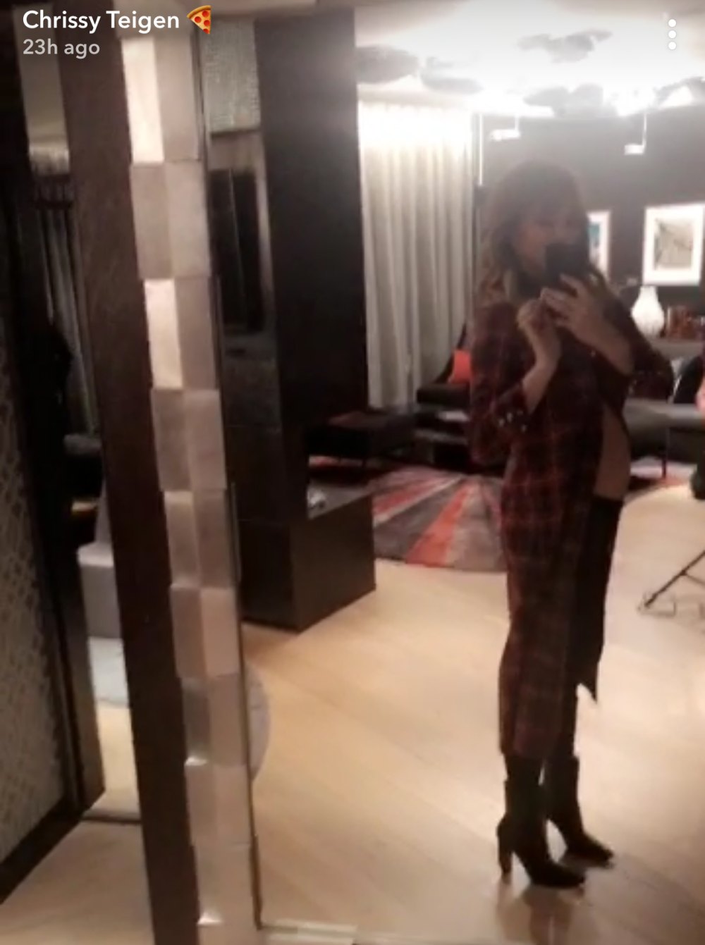 Chrissy Teigen displays her baby bump on Snapchat.