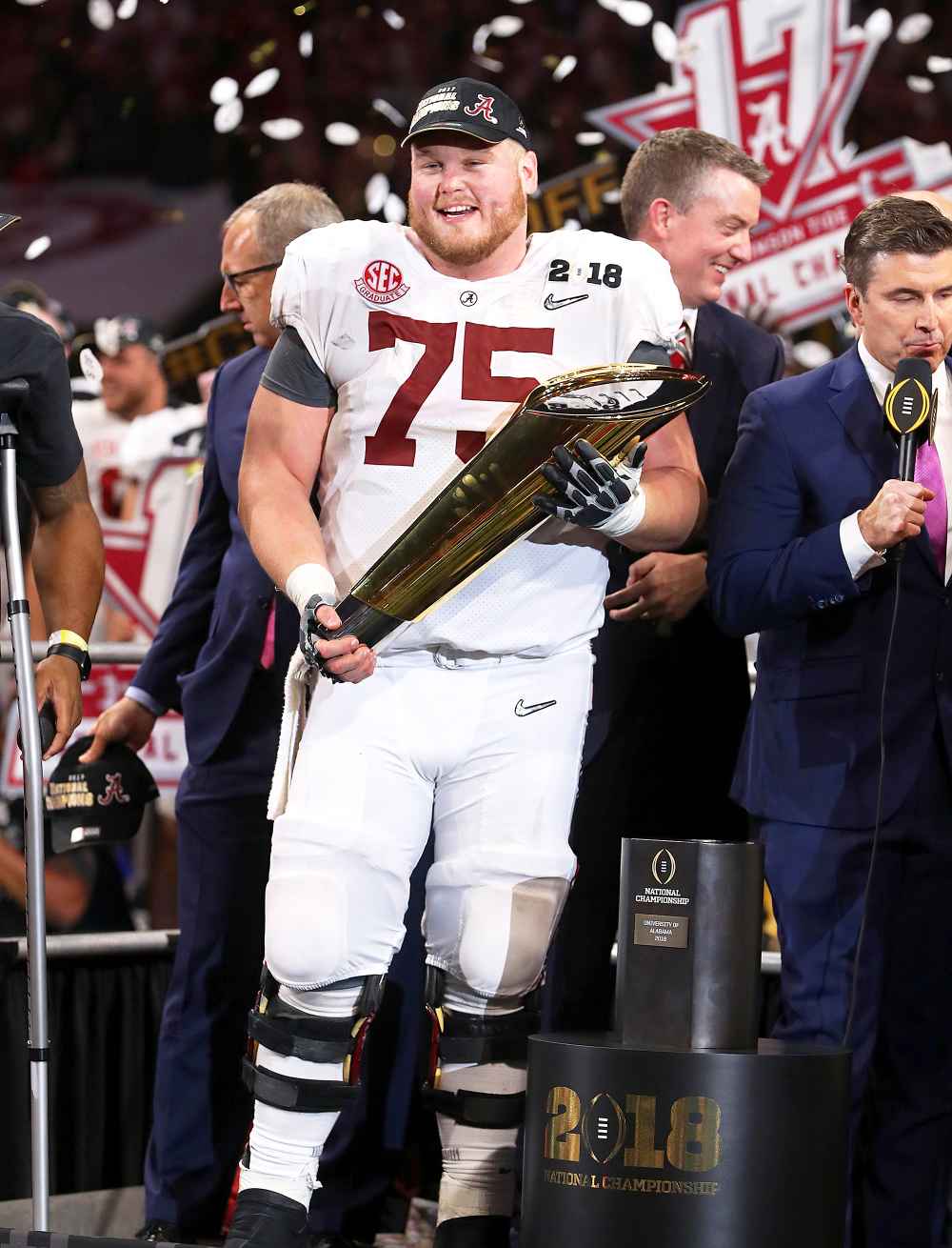 Bradley Bozeman #75 of the Alabama Crimson Tide holds the trophy while celebrating with his team after defeating the Georgia Bulldogs in overtime to win the CFP National Championship presented by AT&T at Mercedes-Benz Stadium on January 8, 2018 in Atlanta, Georgia.