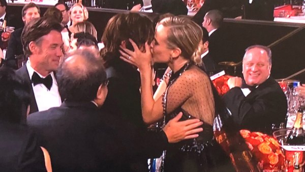 Diane Kruger and Norman Reedus kiss.