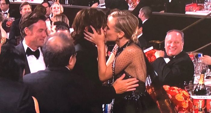 Diane Kruger and Norman Reedus kiss.