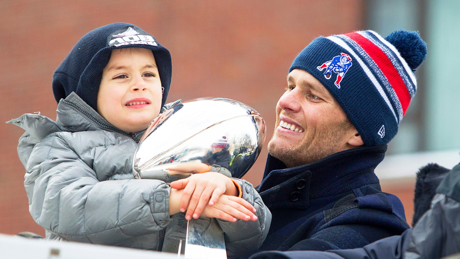 Tom Brady and son Benjamin holds the Lombardi trophy during the New England Patriots Victory 2015 Parade in Boston, Massachusetts.