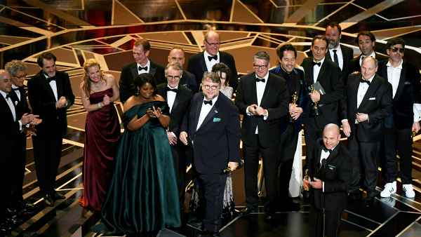 Mexican director Guillermo del Toro stands on stage with his cast and crew after he won the Oscar for Best Film for "The Shape of Water" during the 90th Annual Academy Awards show on March 4, 2018 in Hollywood, California.