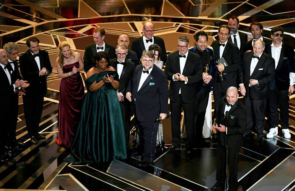 Mexican director Guillermo del Toro stands on stage with his cast and crew after he won the Oscar for Best Film for "The Shape of Water" during the 90th Annual Academy Awards show on March 4, 2018 in Hollywood, California.