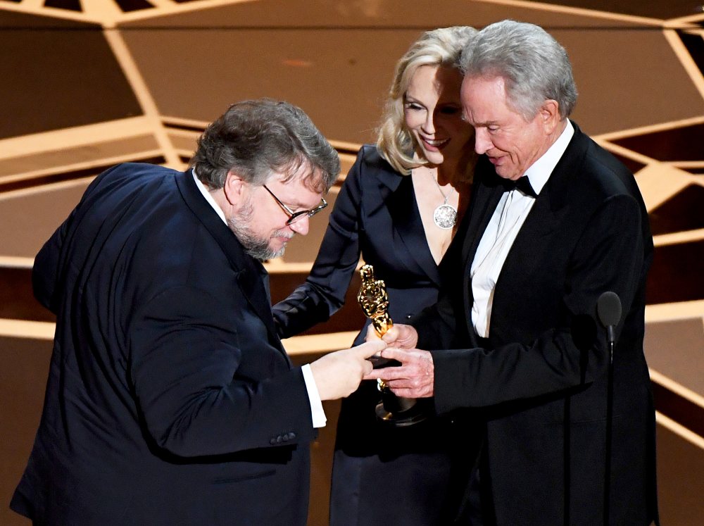 Mexican director Guillermo del Toro accepts the Oscar for Best Film for "The Shape of Water" from Faye Dunaway and Warren Beatty during the 90th Annual Academy Awards show on March 4, 2018 in Hollywood, California.