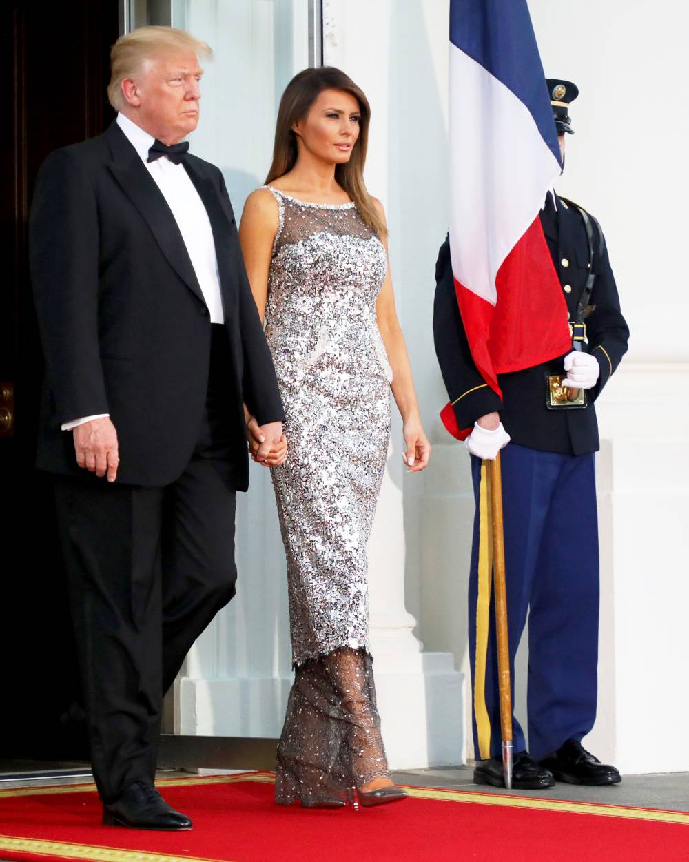 Donald Trump and Melania Trump arrive to welcome French President Emmanuel Macron and his wife, Brigitte Macron for a State Dinner at the North Portico of the White House in Washington, DC April 24, 2018.