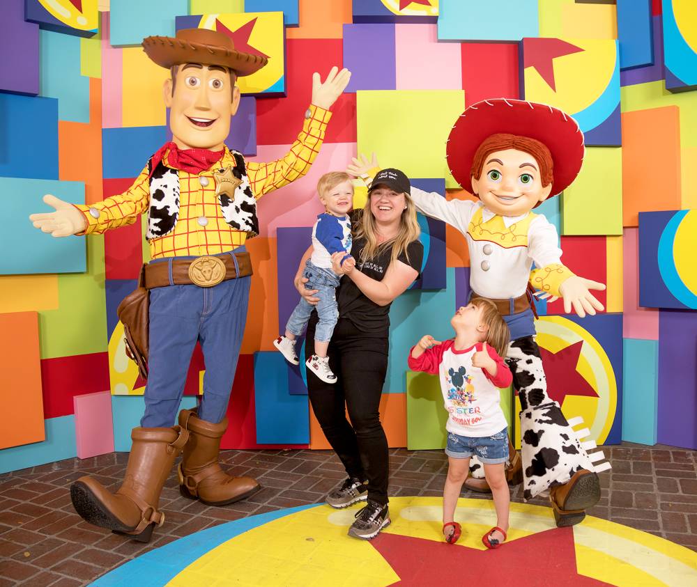 Kelly Clarkson and her children, Remy and River visit with Pixar pals Woody and Jessie at the launch of Pixar Fest at the Disneyland Resort in Anaheim, California.