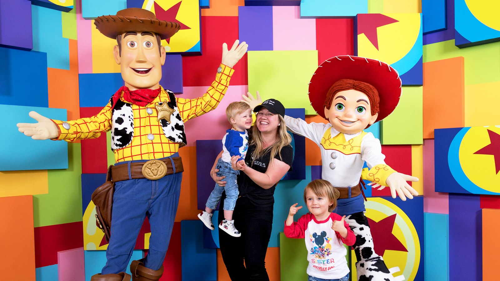 Kelly Clarkson and her children, Remy and River visit with Pixar pals Woody and Jessie at the launch of Pixar Fest at the Disneyland Resort in Anaheim, California.