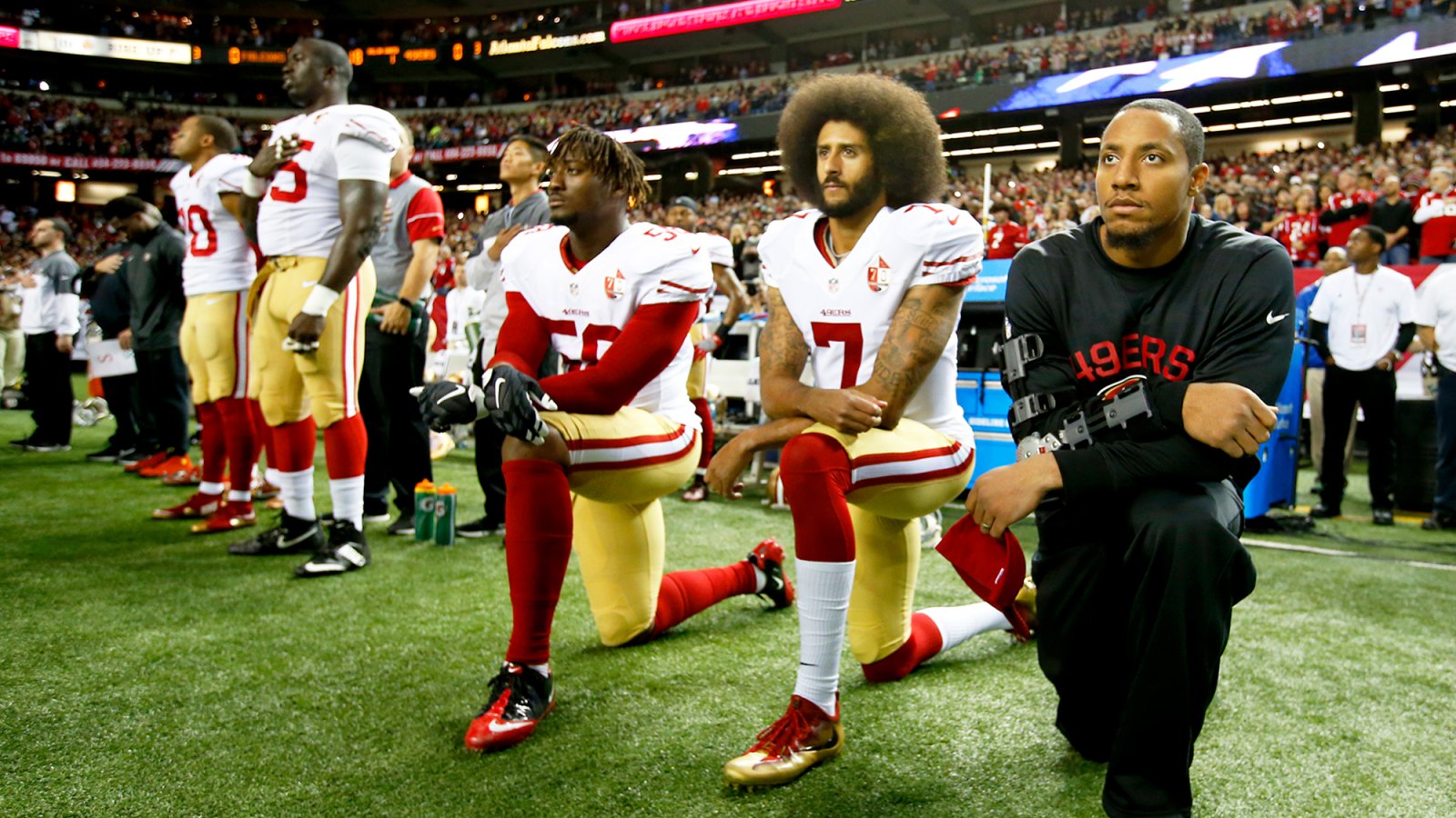 Colin Kaepernick #7 of the San Francisco 49ers kneel on the sideline, during the anthem, prior to the game against the Atlanta Falcons at the Georgia Dome on December 18, 2016 in Atlanta, Georgia.