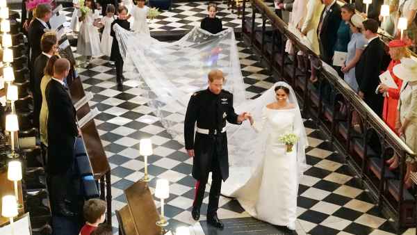 Britain's Prince Harry, Duke of Sussex (L) and Britain's Meghan Markle, Duchess of Sussex, (R) walk away from the High Altar