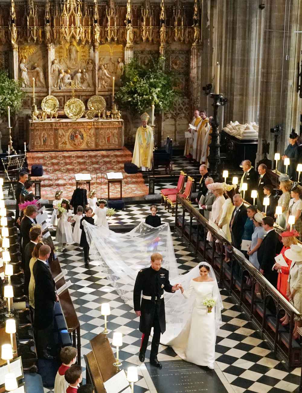 Britain's Prince Harry, Duke of Sussex (L) and Britain's Meghan Markle, Duchess of Sussex, (R) walk away from the High Altar
