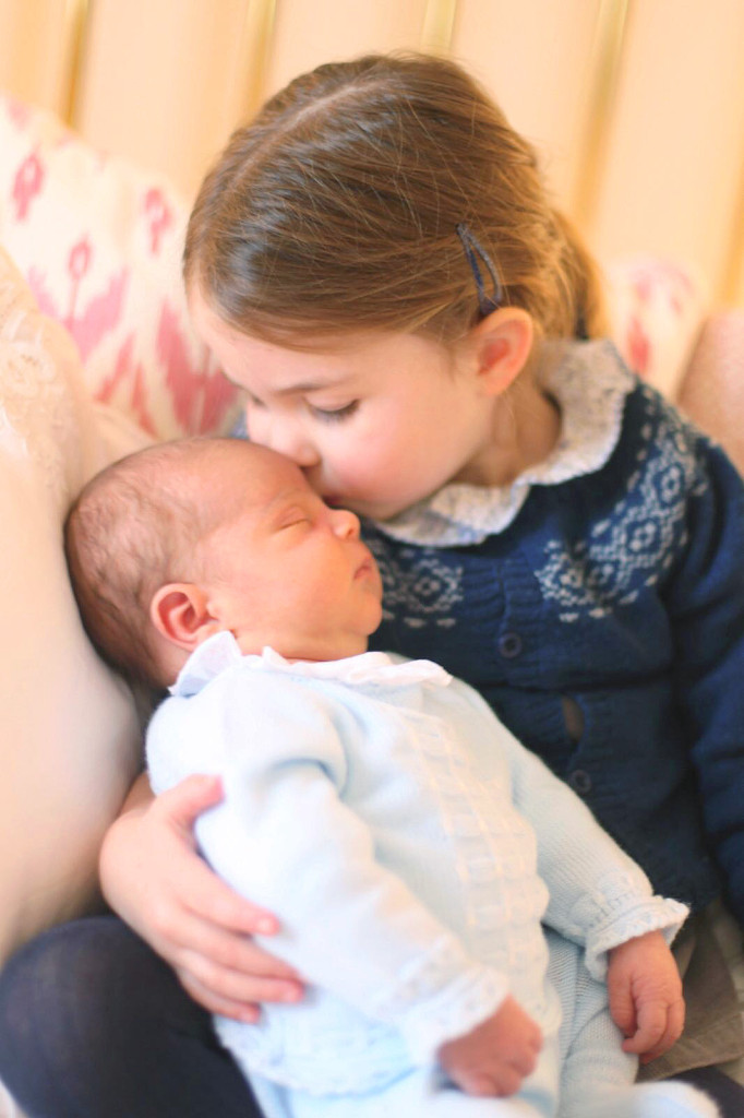 Princess Charlotte kisses Prince Louis on her third birthday on May 2, 2018.