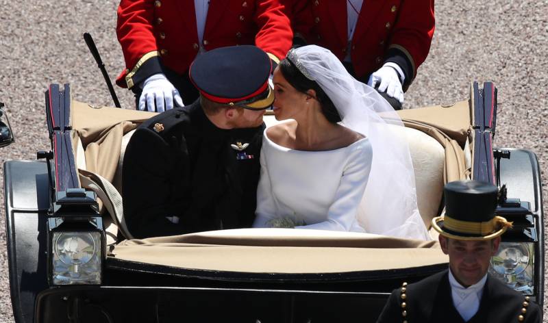 Prince Harry and Meghan Markle share a kiss.