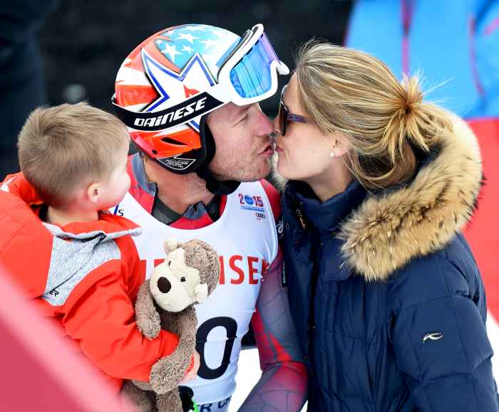 Bode Miller and his wife Morgan Beck while holding their child in the finish area after the 2015 World Alpine Ski Championships men's downhill training in Beaver Creek, Colorado.