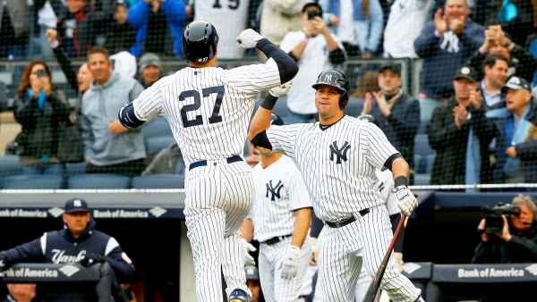 Giancarlo Stanton #27 of the New York Yankees celebrates his first inning two run home run against the Tampa Bay Rays with teammate Gary Sanchez #24 at Yankee Stadium on April 4, 2018 in the Bronx borough of New York City.