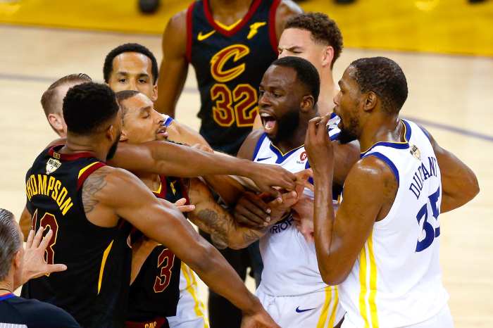 Tristan Thompson #13 of the Cleveland Cavaliers and Draymond Green #23 of the Golden State Warriors exchange words