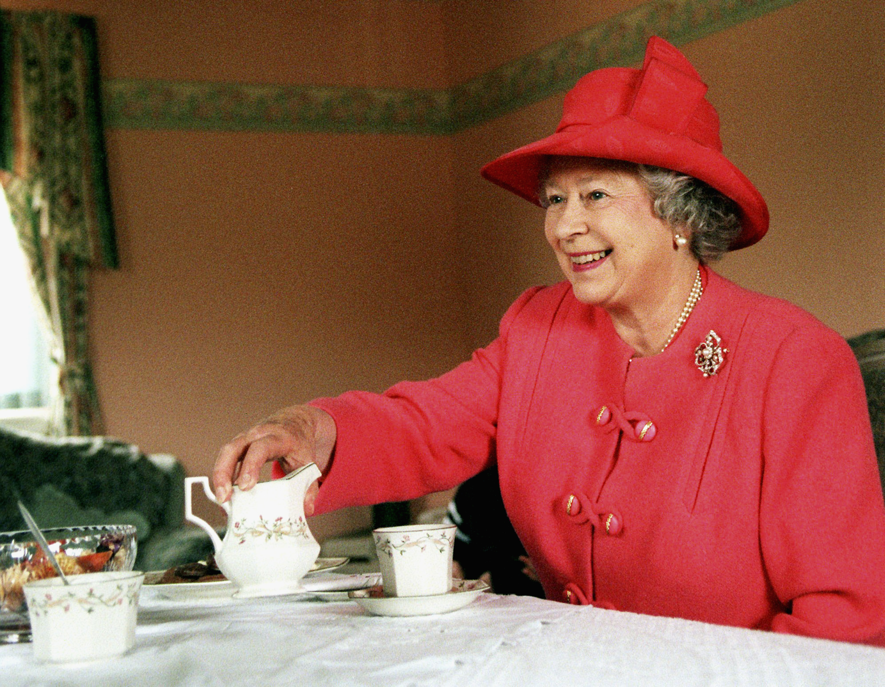 Queen Elizabeth drinking tea